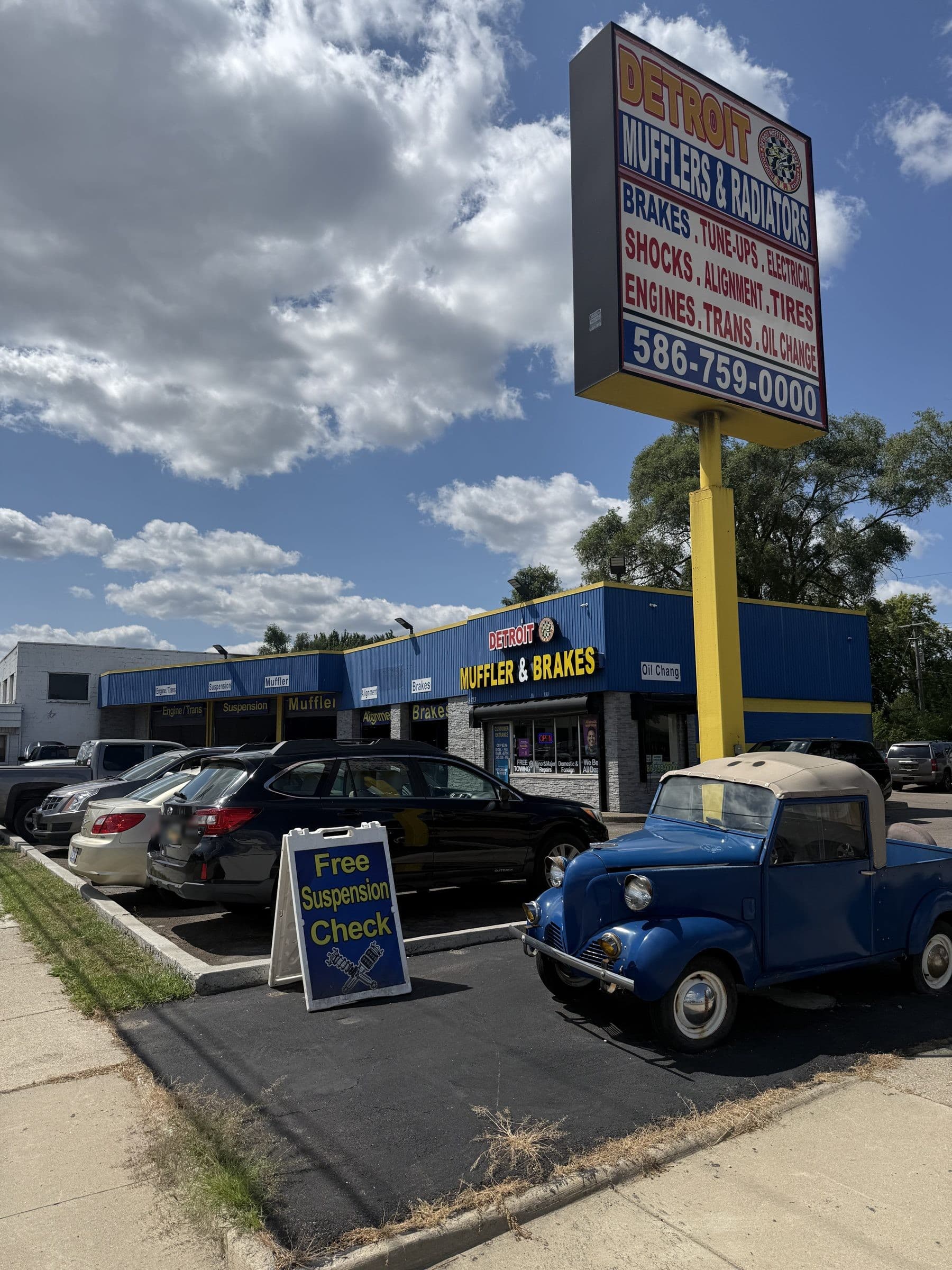The shop's tall roadside sign listing brakes, exhaust, shocks, alignment and tires