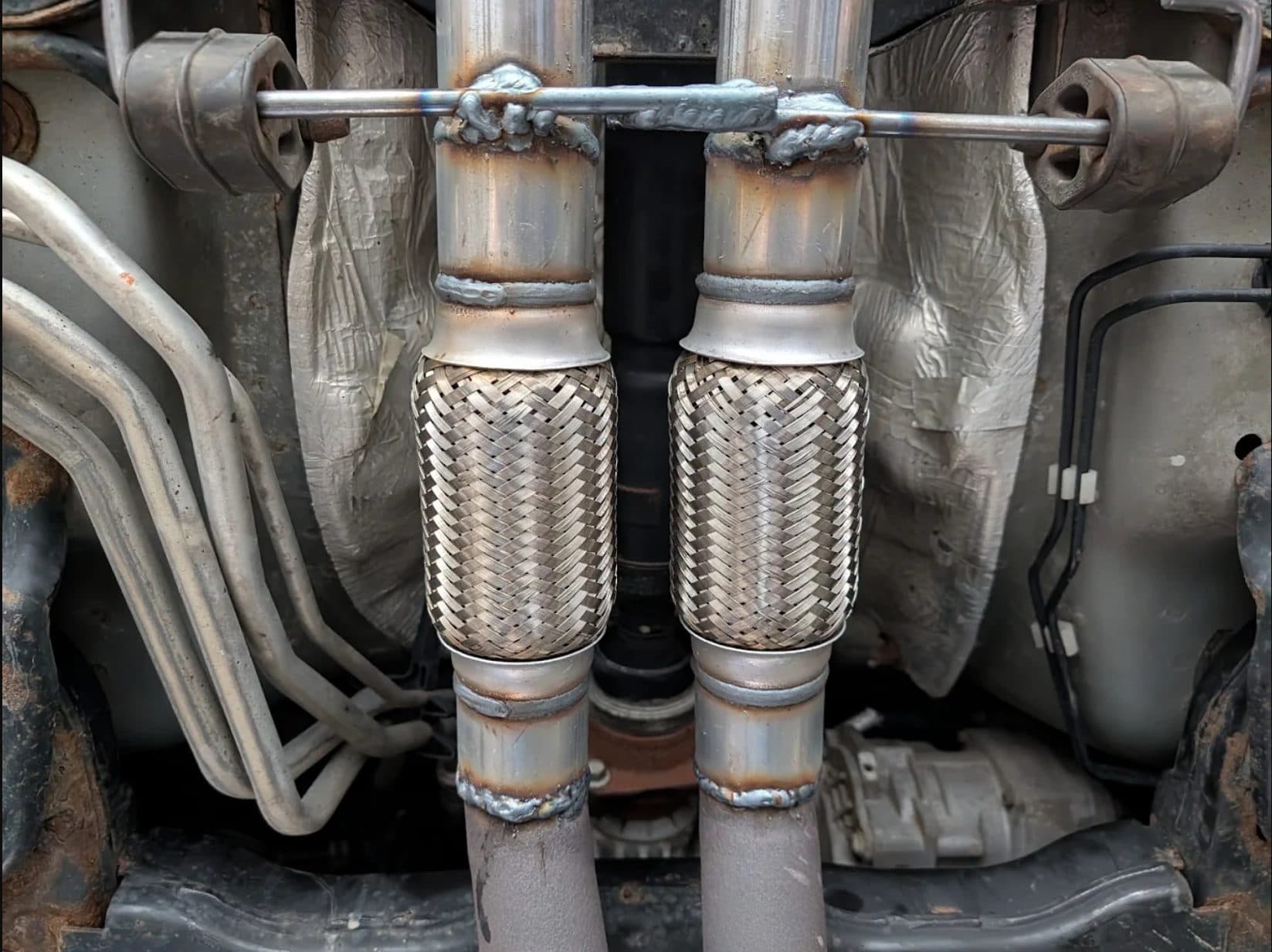 Close-up of freshly welded dual exhaust flex pipes
